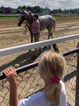 Candid girl watching racehorse