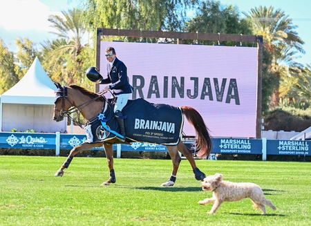 Conor Swail on Theo 160 accompaanied by wails dog Ralph High Deseert Sport Photo