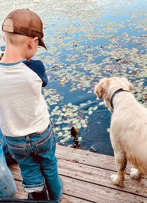 candid boy dog at pond Farly