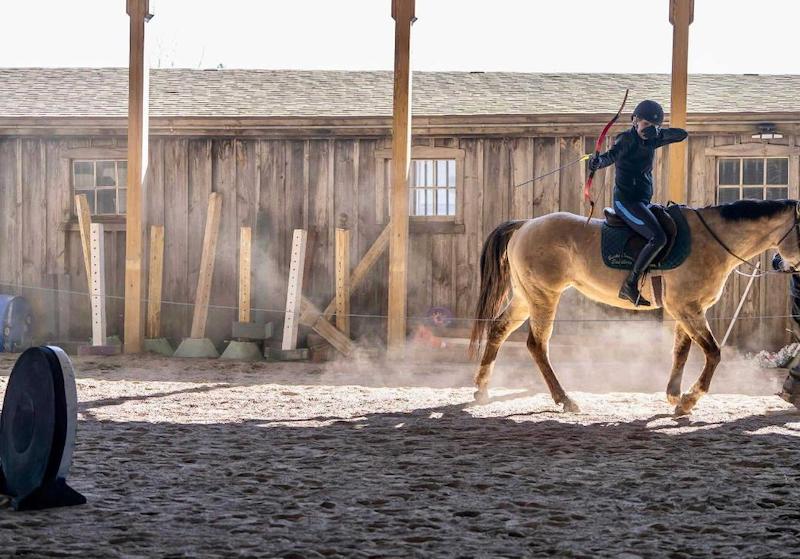 candid girl shooting arrow Ginny